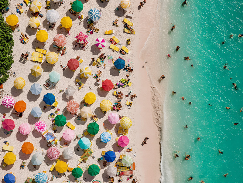 A Caribbean beach full of colorful umbrellas.